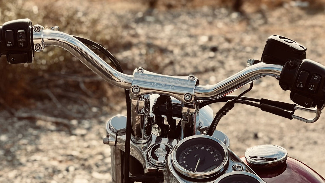 Harley-Davidson Dyna handlebar setup featuring chrome risers, handlebars, factory controls and gauges.