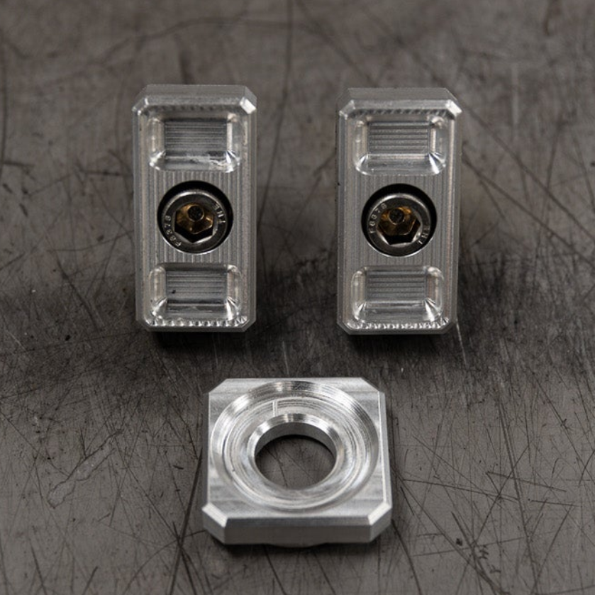 Billet Dyna axle adjuster blocks with stainless steel hardware and a specialty washer