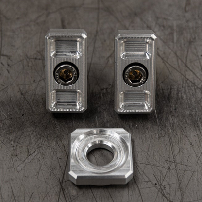 Billet Dyna axle adjuster blocks with stainless steel hardware and a specialty washer