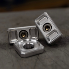 Billet Dyna axle adjuster blocks with stainless steel hardware and a specialty washer