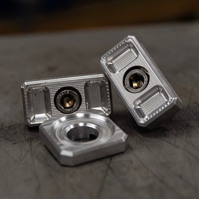 Billet Dyna axle adjuster blocks with stainless steel hardware and a specialty washer