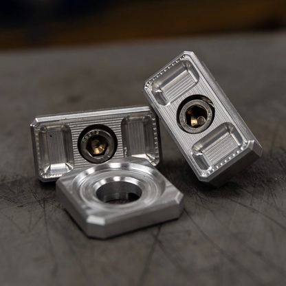 Billet Dyna axle adjuster blocks with stainless steel hardware and a specialty washer